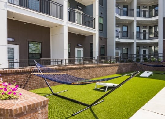 a rendering of a building with grass and benches