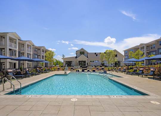 A large swimming pool in the middle of a resort area.