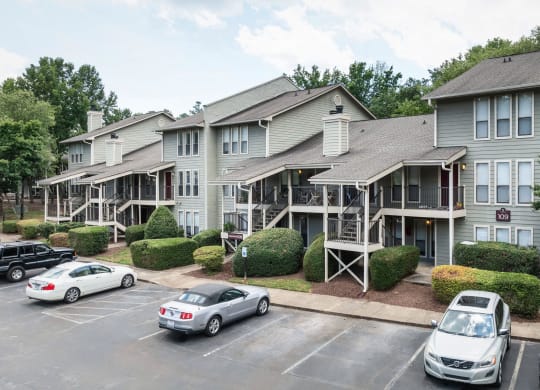 the apartment building with cars parked in front of it