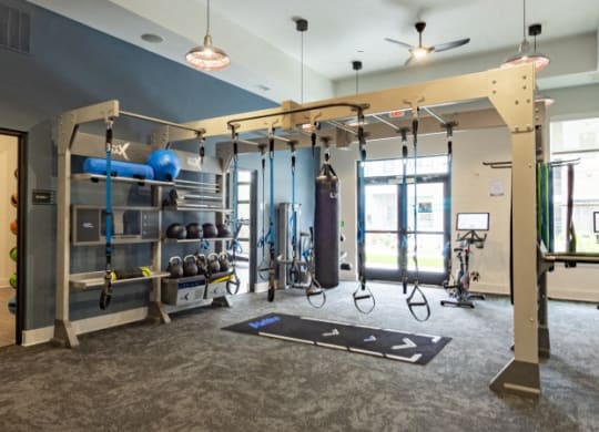 a boxing gym with punching bags and punching bags hanging from the ceiling