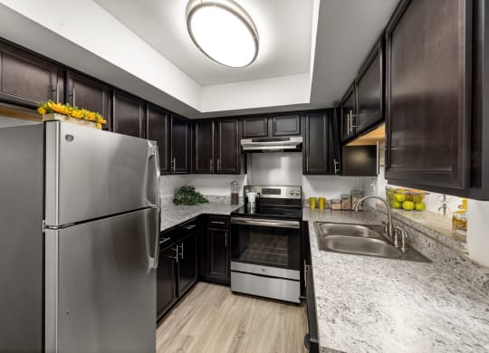 a kitchen with stainless steel appliances and marble counter tops