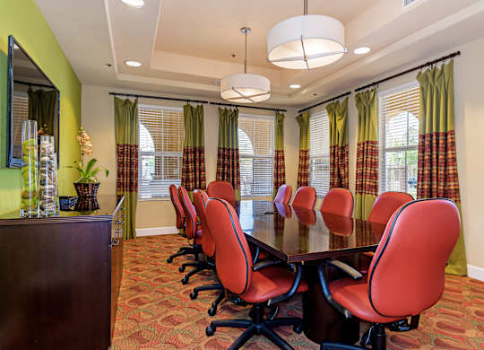 A conference room with a long table and chairs.