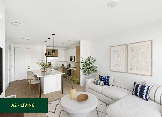A modern living room with a white couch and a dining area in the background.