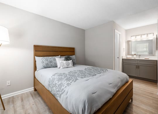 a bedroom with a bed and a bathroom with a sink at View at Lake Lynn, Raleigh North Carolina