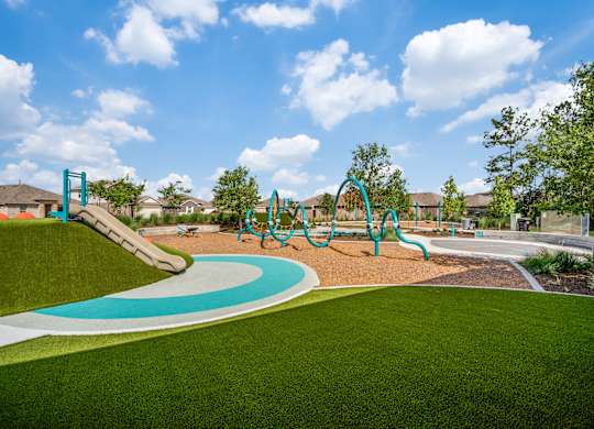 A playground with a blue and green slide.