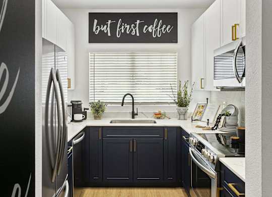 A kitchen with a sign that says "but first coffee".