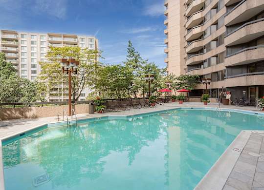 a large swimming pool in the middle of two apartment buildings