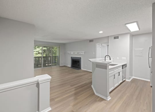 an open kitchen and living room with a fireplace