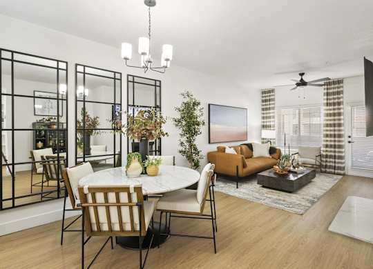 A modern living room with a dining table and chairs.