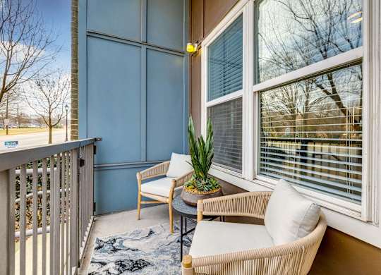 A private balcony with stylish furniture offered at Midtown 205, luxury partments, Charlotte, NC.