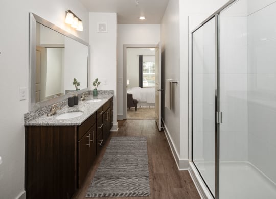 a bathroom with a shower and a sink and a mirror