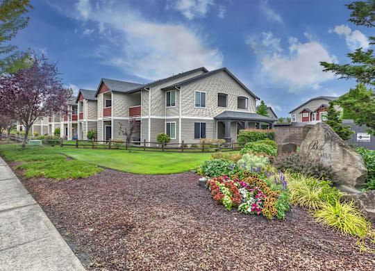 A large house with a garden in front.