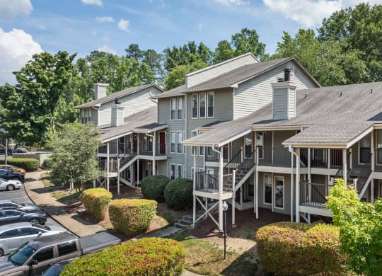 an aerial view of the apartment complex with a parking lot