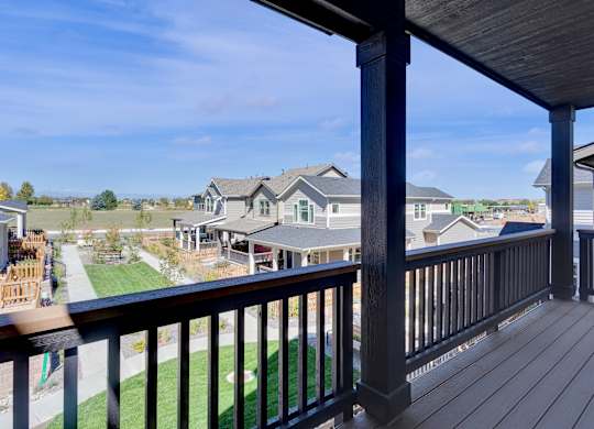 the view from the deck of a home with a yard and houses