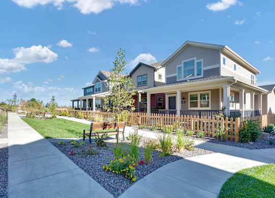 a house with a yard and a sidewalk in front of it
