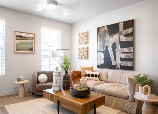 a living room with a beige couch and a wooden coffee table