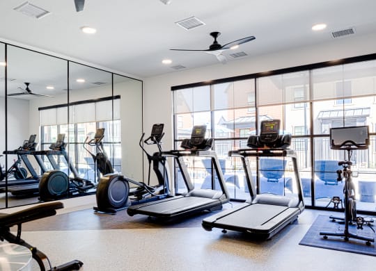 a gym with treadmills and other exercise equipment