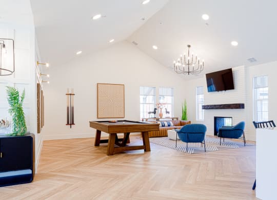 a living room with a pool table and a tv
