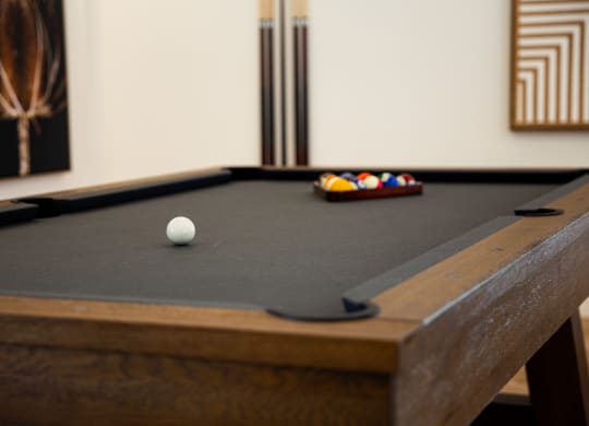 a pool table in a room with a billiard ball on it