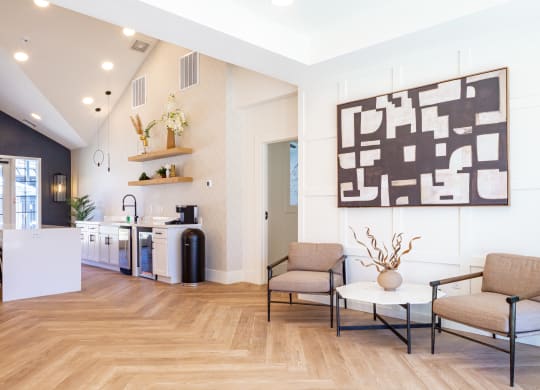 a living room with two chairs and a table