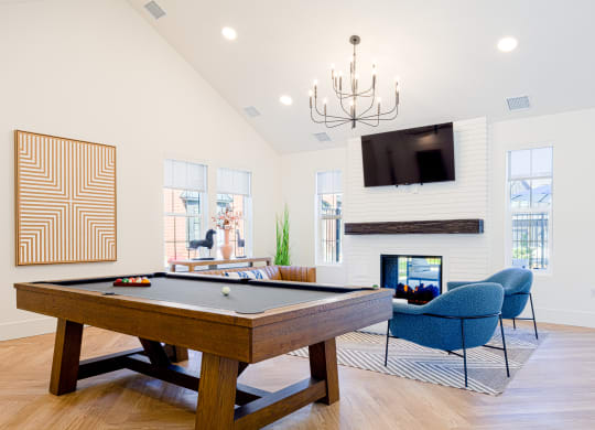 the preserve at ballantyne commons pool table and living room with fireplace