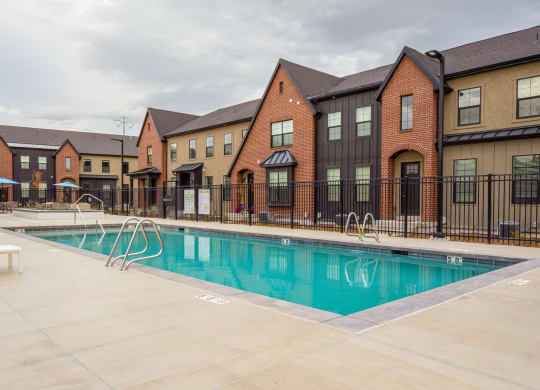 our apartments feature a swimming pool and a courtyard with lounge chairs