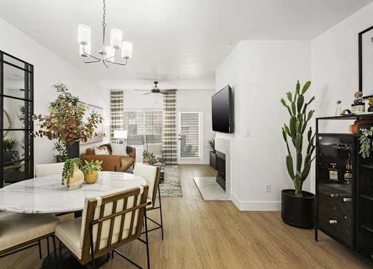 A dining room with a table and chairs.