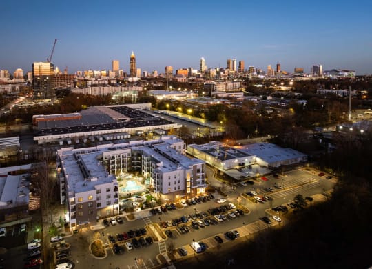the campus at night with the city skyline in the background