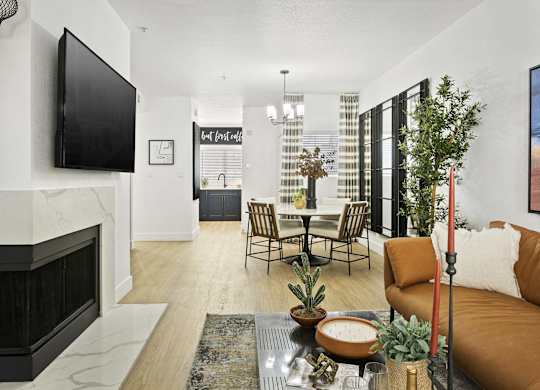 A living room with a fireplace and a television on the wall.