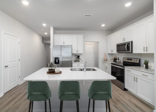 a kitchen with white cabinets and a white counter top