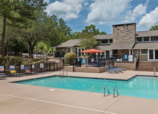 the pool with the apartment building in the background