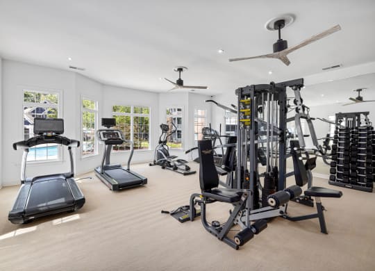 the gym has plenty of exercise equipment and windows at Mariners Crossing, Raleigh, 27613