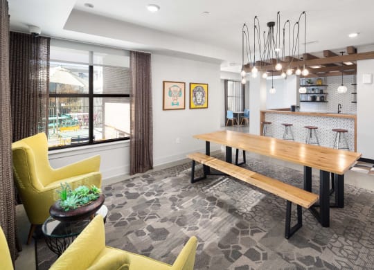 a dining room with a wooden table and yellow chairs