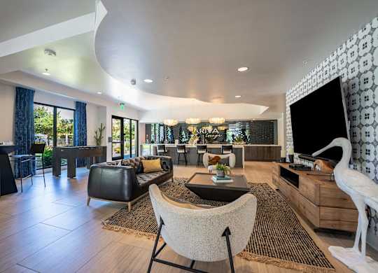 A modern living room with a black and white patterned wall.