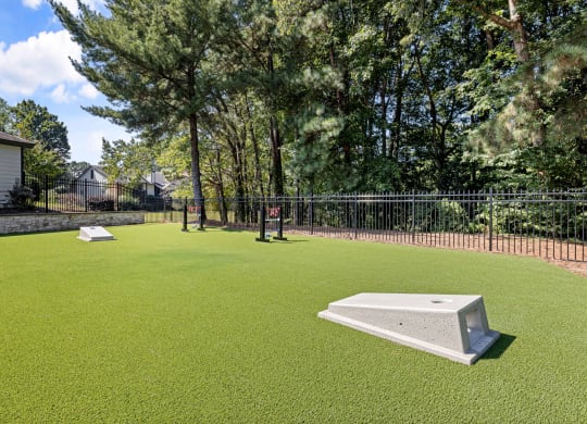 a yard with a pool and a fence and trees at View at Lake Lynn, Raleigh, NC