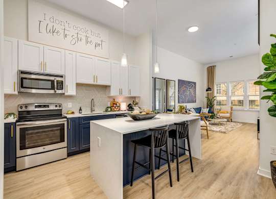 A greatroom and kitchen with center island, offered at Midtown 205, recognized as best apartments in Charlotte, NC.