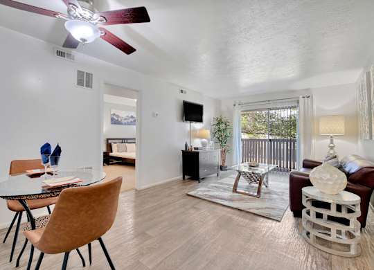 A living room with a brown chair and a glass table.