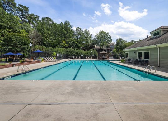 the swimming pool at our apartments with trees in the background