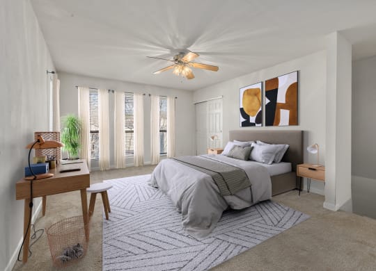 a bedroom with a bed and a ceiling fan