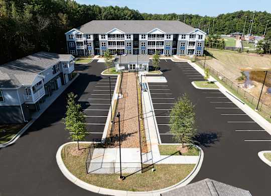 A large building with a parking lot in front of it.