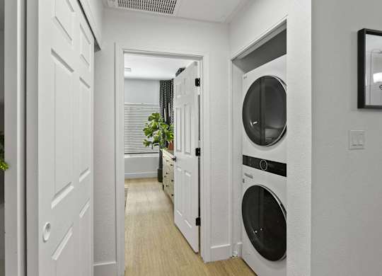 A white laundry room with a washer and dryer.