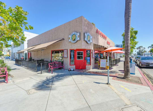 a building with a red door and a clock on the side of it