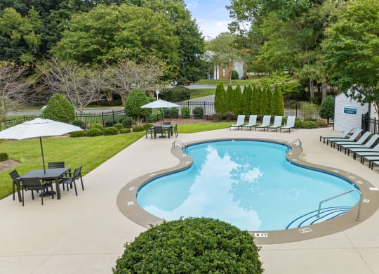 a swimming pool with lounge chairs and umbrellas at the resort at View at Lake Lynn, Raleigh North Carolina