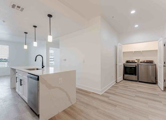a kitchen with an island and a stove and a refrigerator