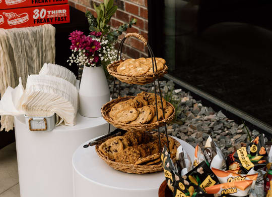 a table of food at a wedding reception with a brick wall in the background  at Embold, Lehi, UT