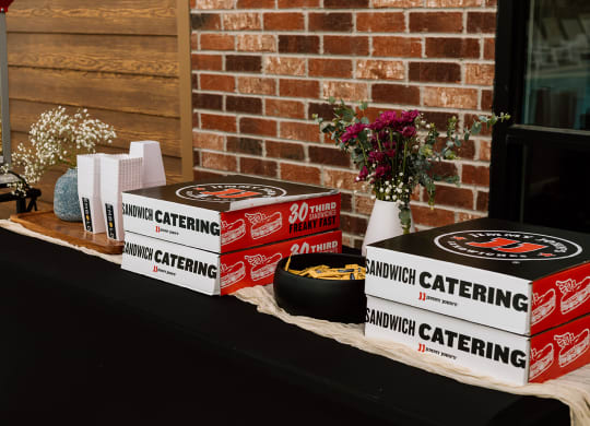 a table with a bunch of boxes of food on it  at Embold, Lehi, Utah