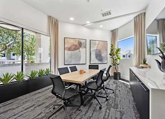 A conference room with a long table and chairs.
