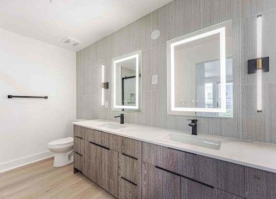 a bathroom with two sinks and a toilet