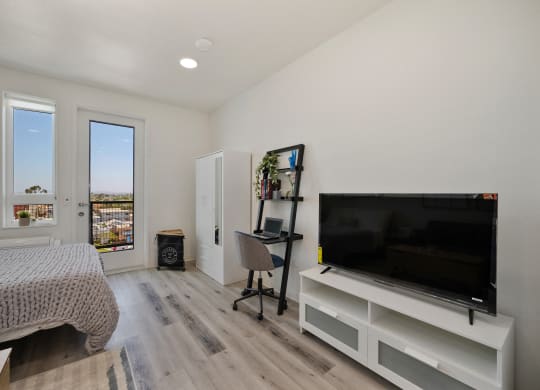 a bedroom with a large tv and a bed
