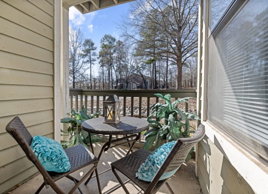 a patio with a table and chairs on a balcony